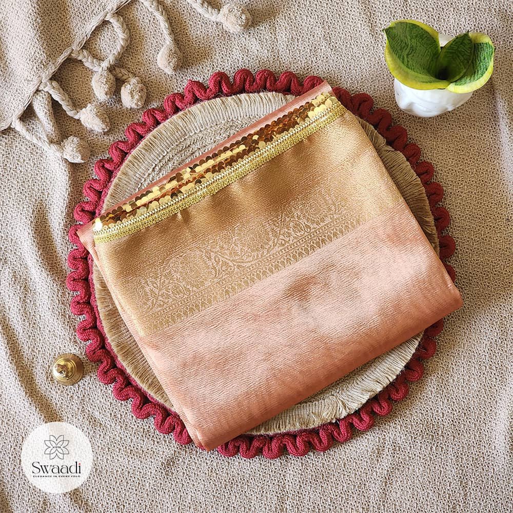 Surangini – Elegant Orange Tissue Saree with Lace Borders